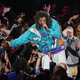 J. Cole interacts with fans during the 2019 All-Star Game in Charlotte.